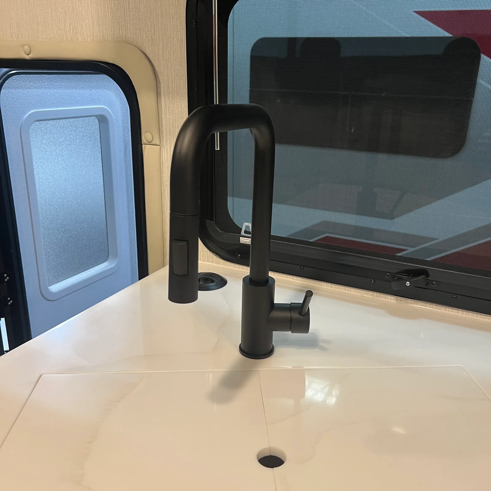 2027 Nexus Ghost 36DS Super C motorhome, kitchen sink with black faucet and window