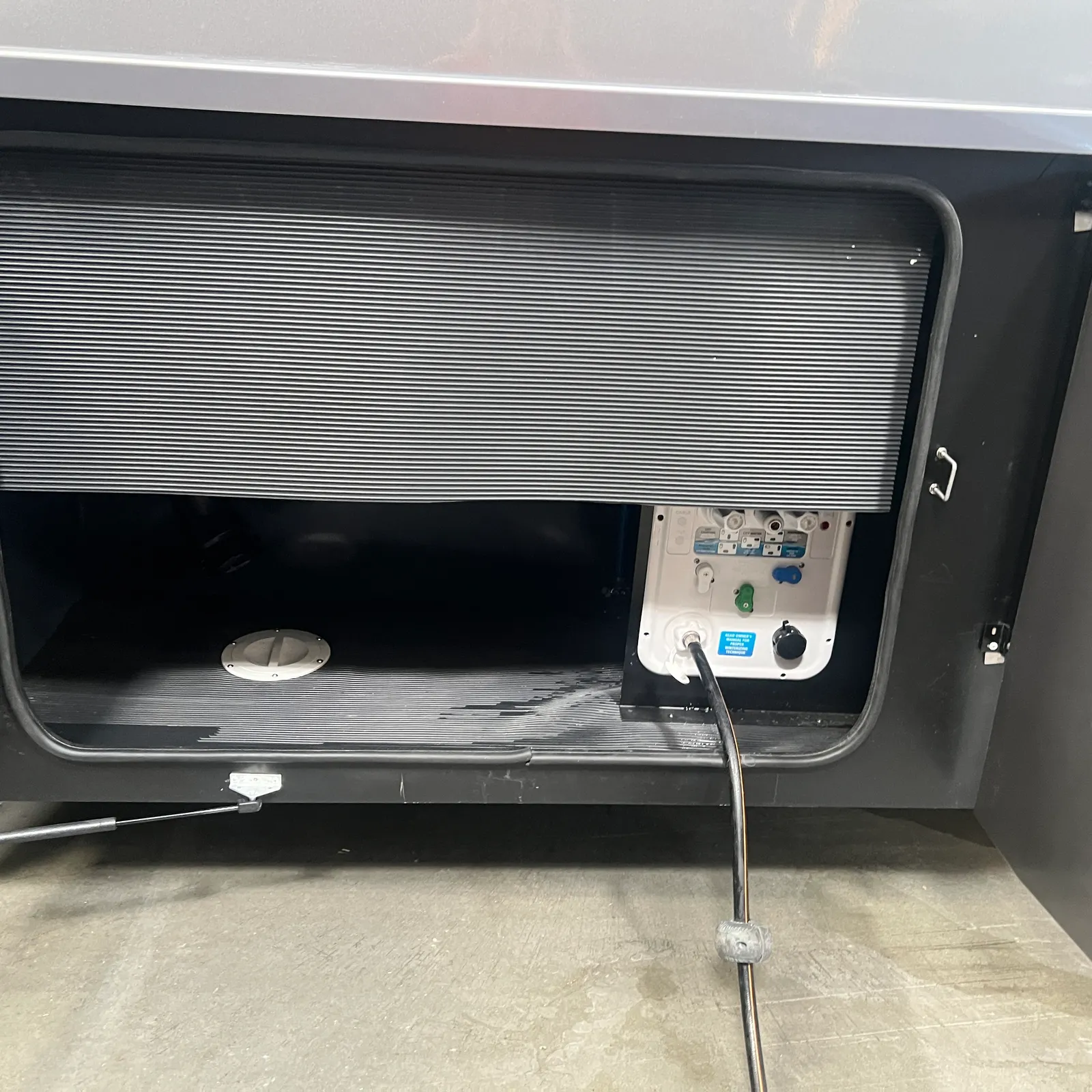 2027 Nexus Ghost 36DS Super C motorhome, storage bay with roller door, power control panel and exterior hookups