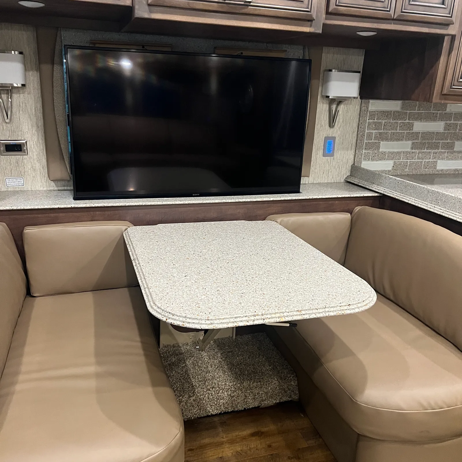 2019 Newmar Ventana 4045 Class A Diesel Pusher motorhome, dinette with table and bench seating facing mounted flat-screen television
