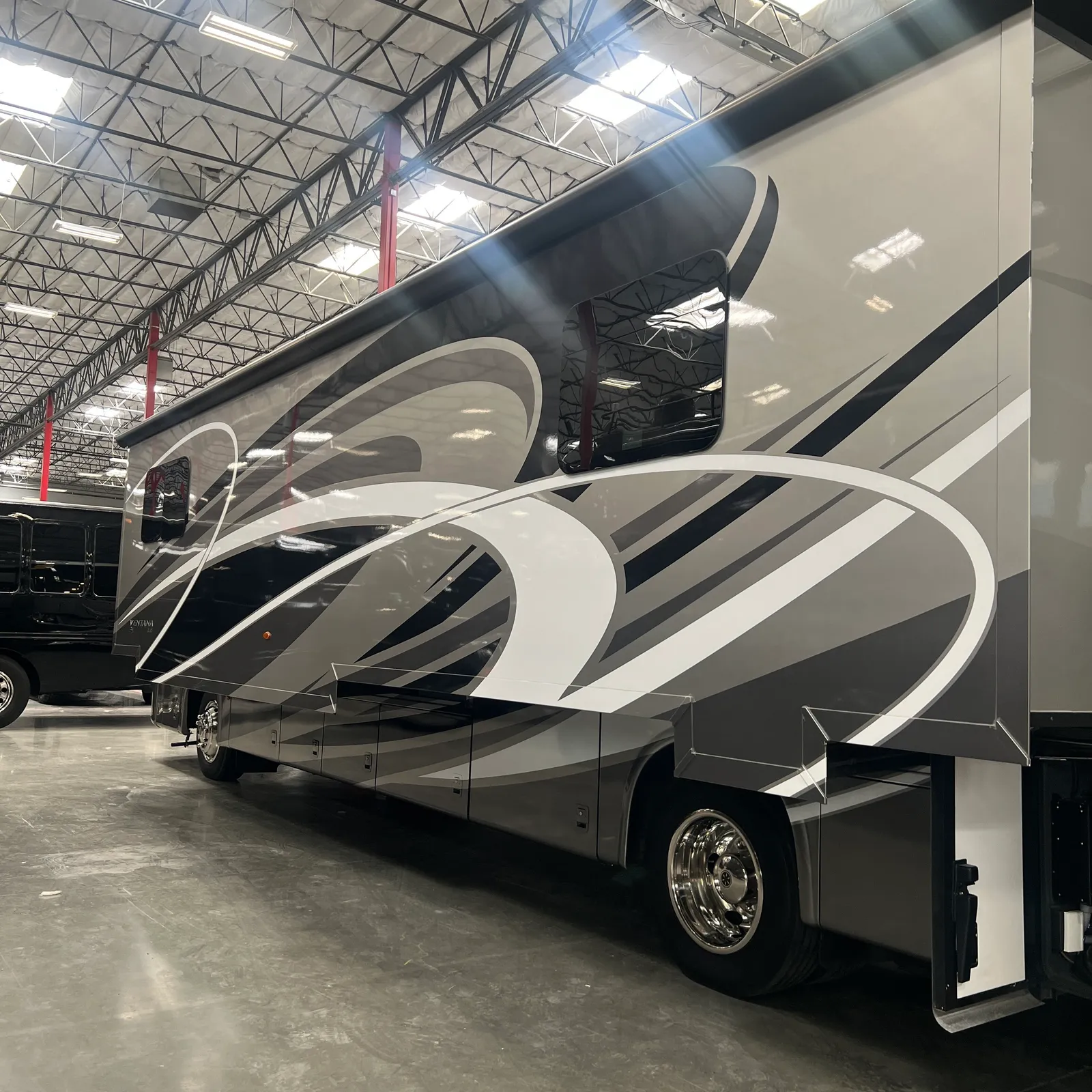2019 Newmar Ventana 4045 Class A Diesel Pusher motorhome, motorhome with black and white stripe graphics parked in warehouse