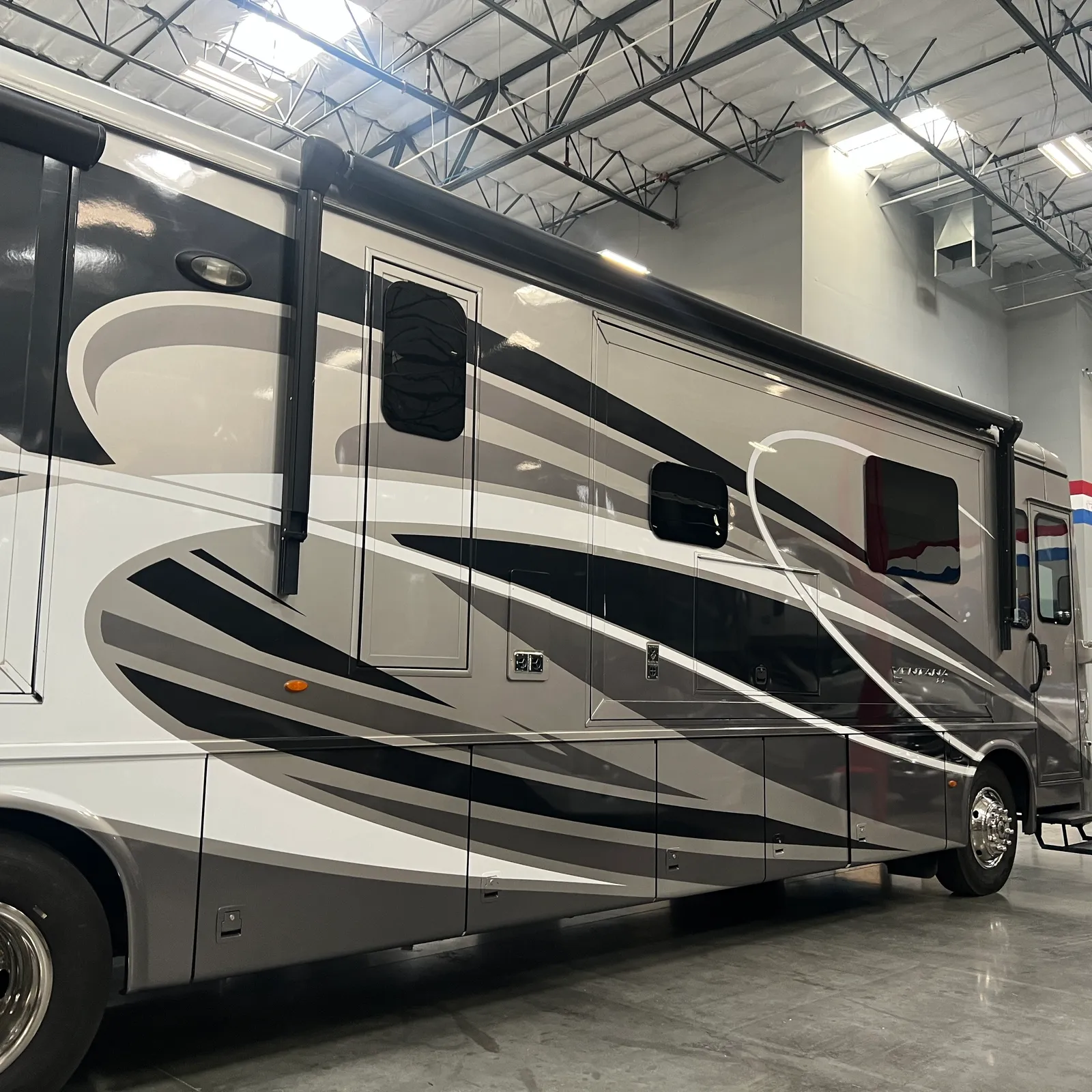 2019 Newmar Ventana 4045 Class A Diesel Pusher motorhome, motorhome with black and white graphics and tinted windows in showroom