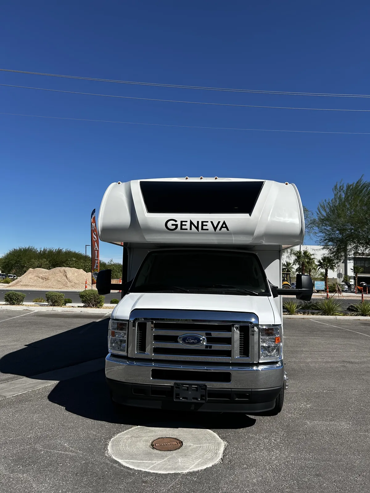 2023 Thor Motor Coach Geneva Class C motorhome, front view of white class c motorhome with ford chassis in parking lot