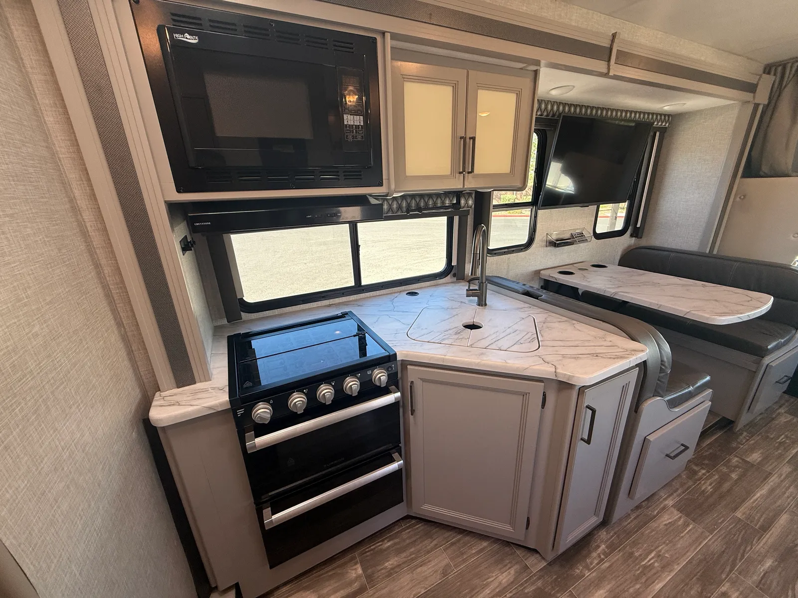 2023 Thor Motor Coach Geneva Class C motorhome, kitchen with stove, microwave, cabinets and countertops