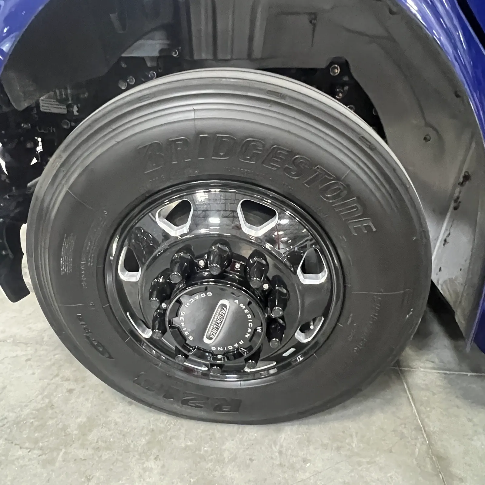 2027 Dynamax Corp Europa S 37CA Super C motorhome, large bridgestone tire and chrome wheel on motorhome