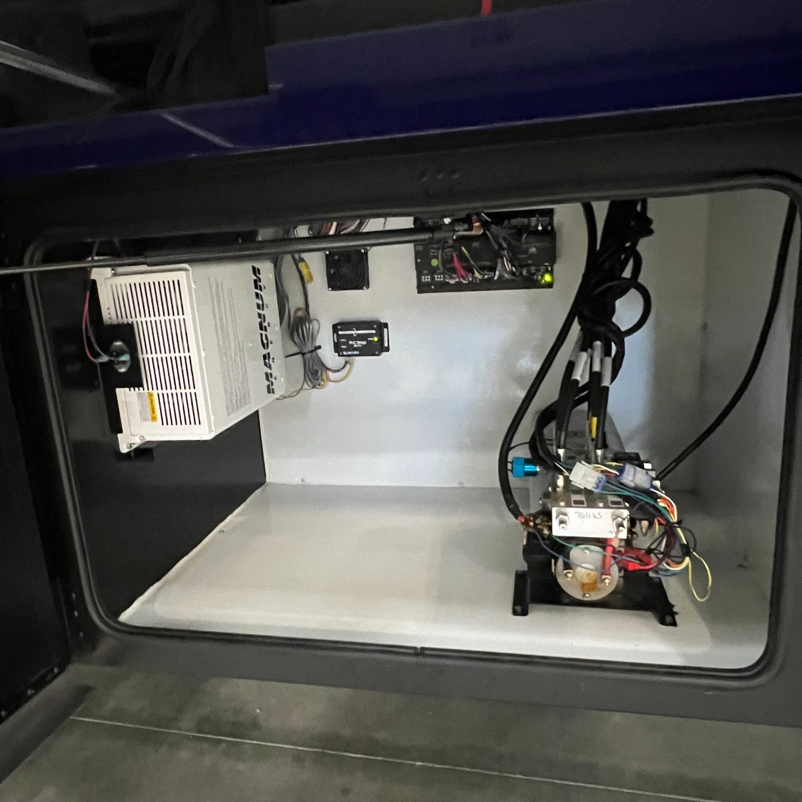 2027 Dynamax Corp Europa S 37CA Super C motorhome, storage bay with power converter, fuses, and electrical components