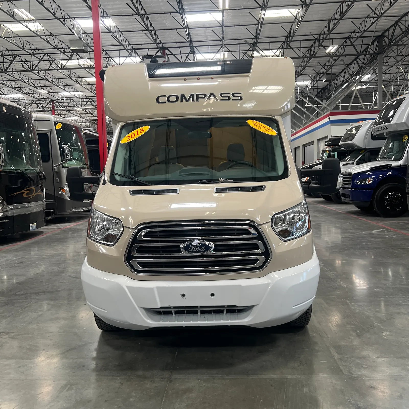2018 Thor Motor Coach Compass 23TR Class C motorhome, front view of cream and white motorhome with compass nameplate