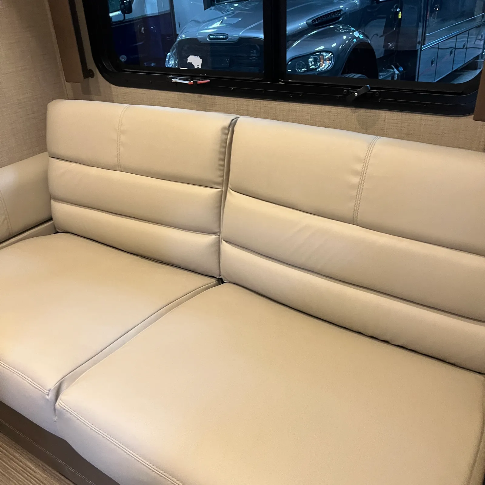 2018 Thor Motor Coach Compass 23TR Class C motorhome, cream-colored banquette seating with padded backrest and window above