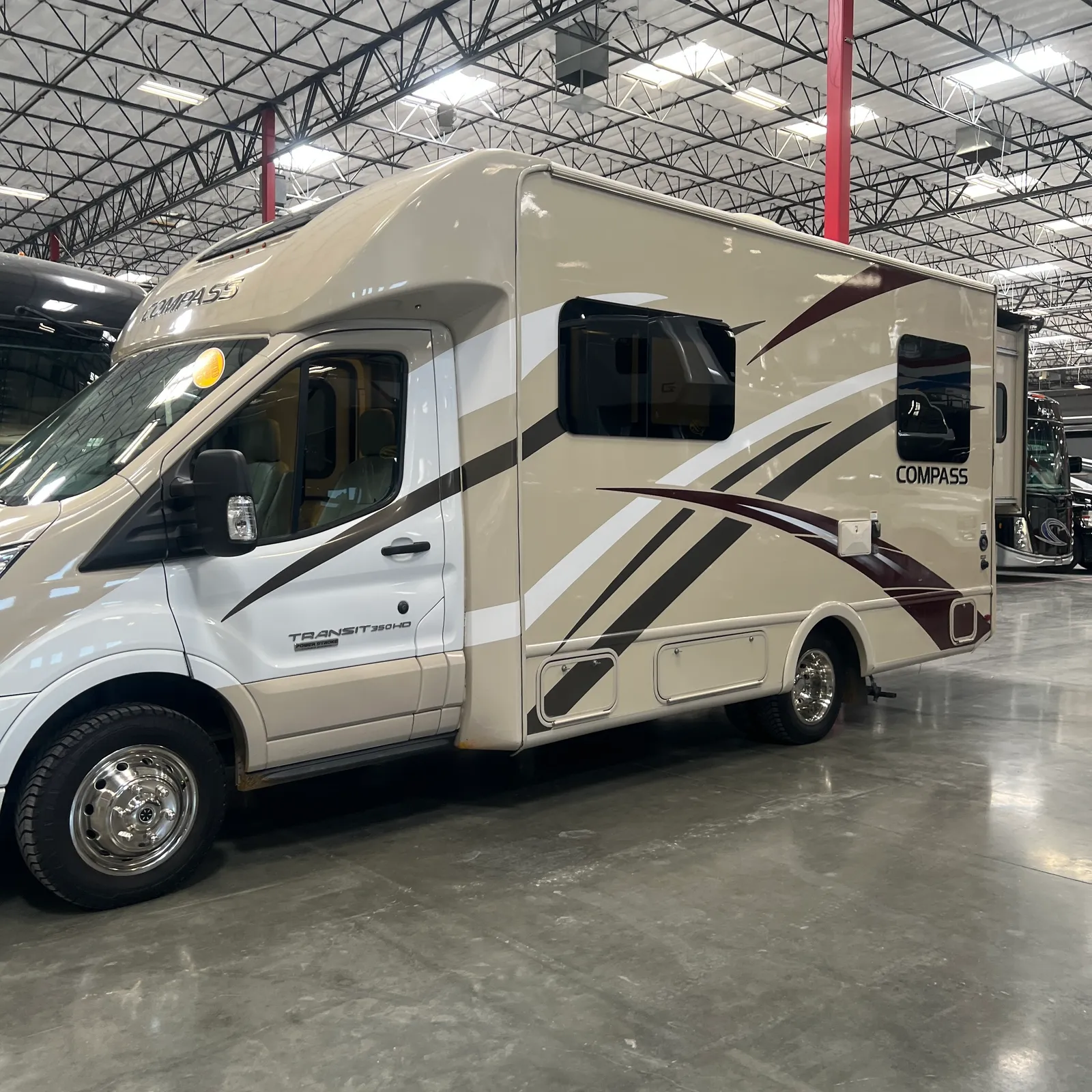 2018 Thor Motor Coach Compass 23TR Class C motorhome, class c motorhome with tan and white exterior in indoor showroom