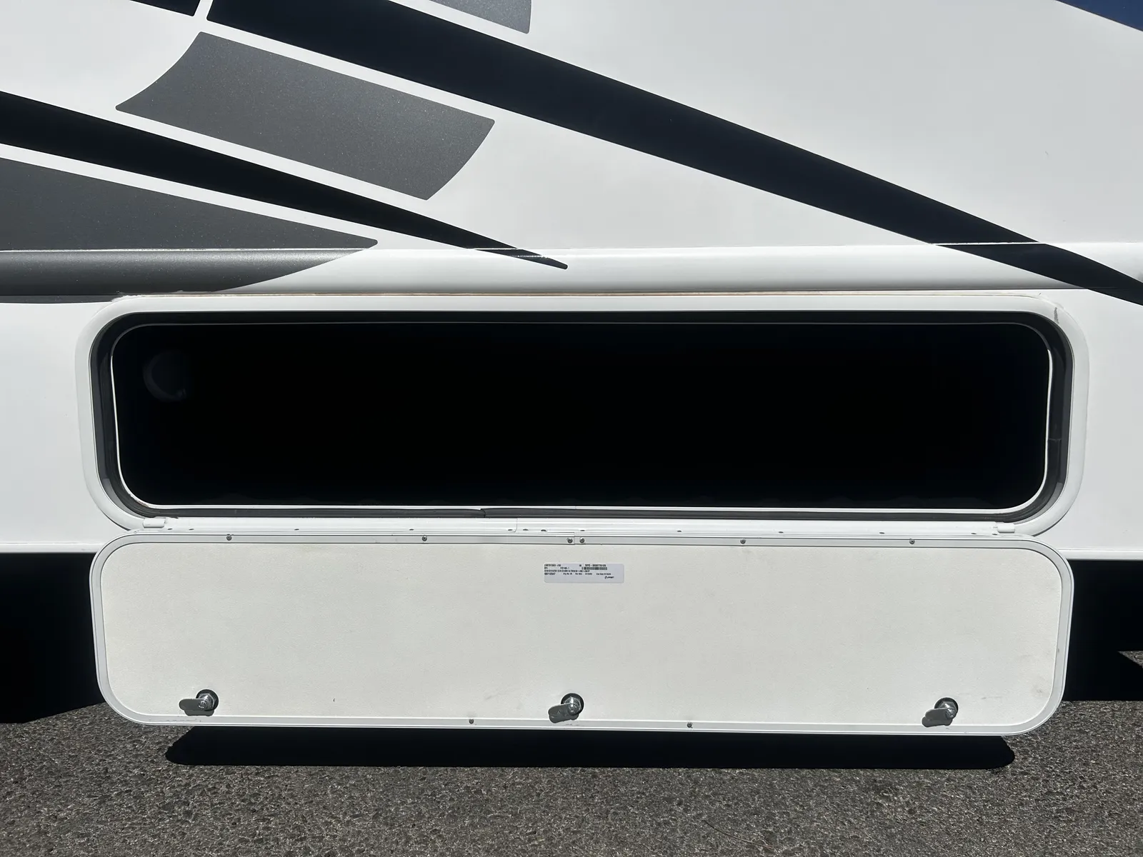 2023 Thor Motor Coach Four Winds Super C motorhome, coach side with large window and storage compartment door