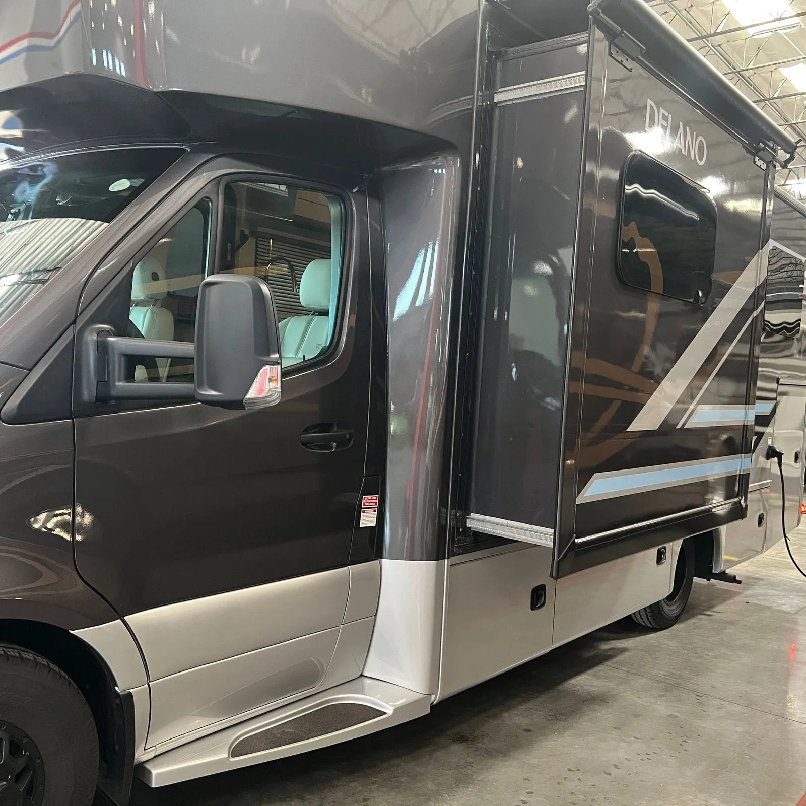 2026 Thor Delano 24XL Class C motorhome, side view of motorhome with open driver door showing cab interior