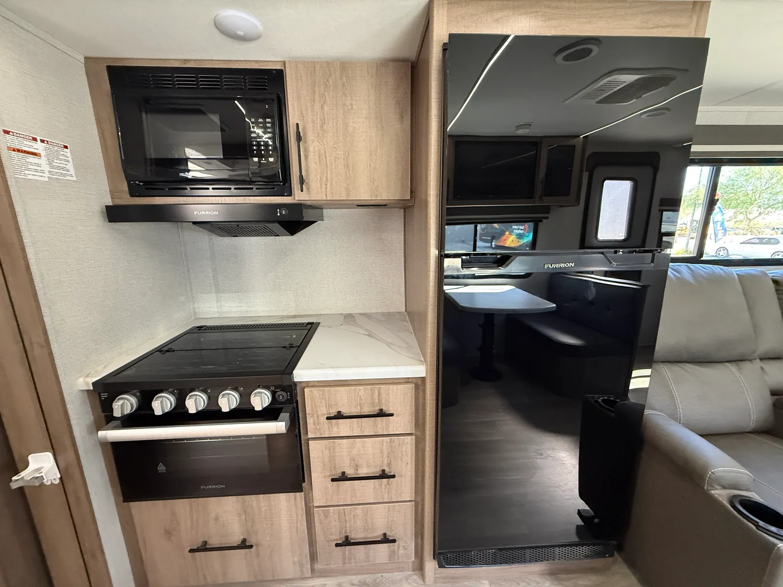 2024 Grand Design Imagine Xls 22MLE Travel Trailer motorhome, galley with stove, oven, microwave, and storage cabinets