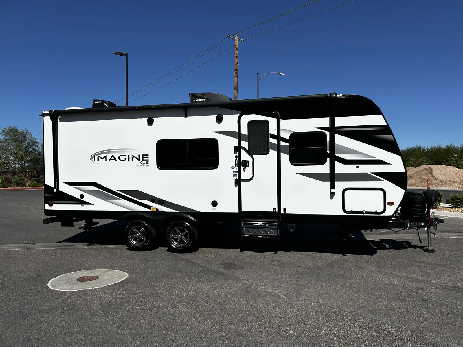 2024 Grand Design Imagine Xls 22MLE Travel Trailer motorhome, white and black travel trailer with awning and entry door