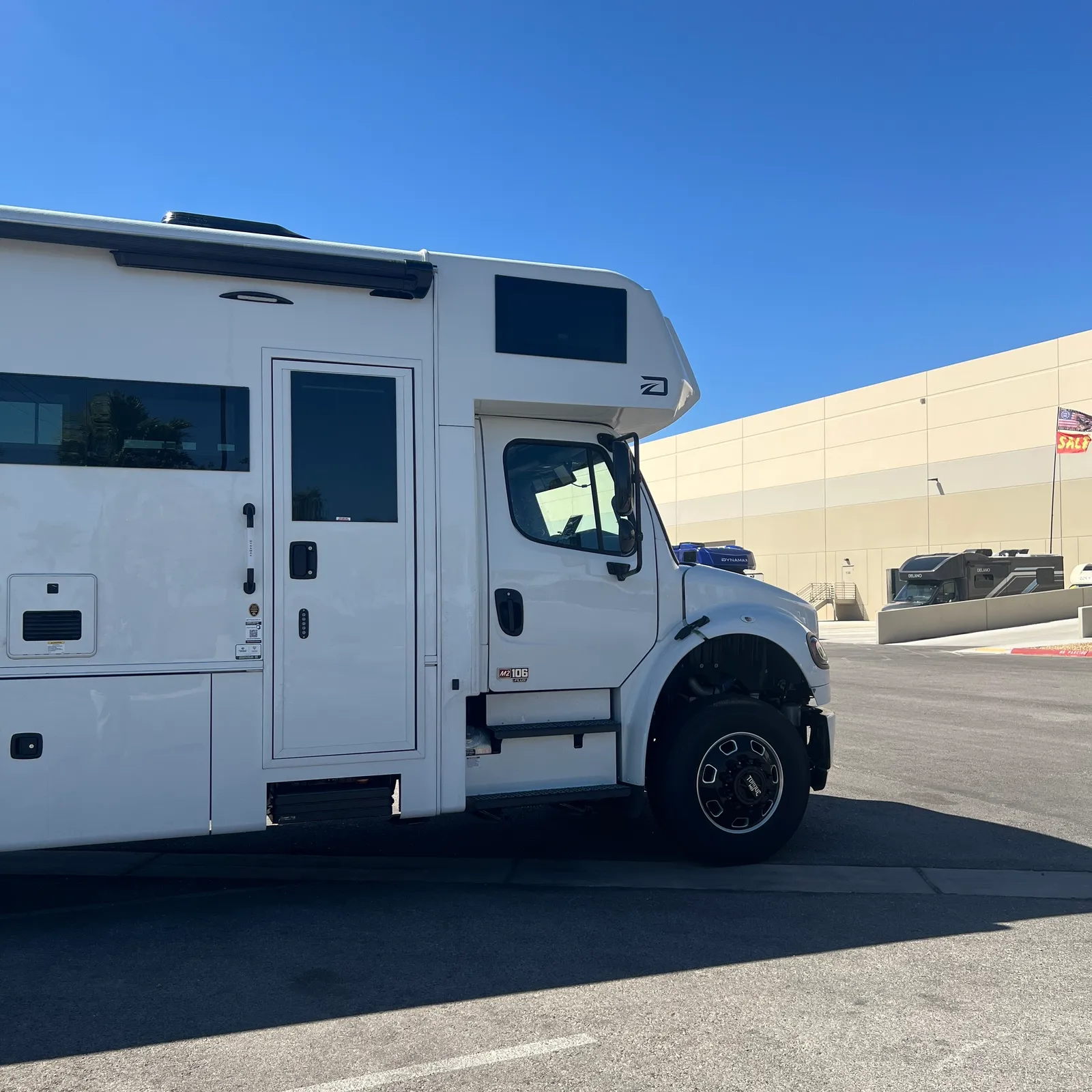 2027 Dynamax Corp Europa 31SS Super C motorhome, white class c motorhome with cab door and side windows