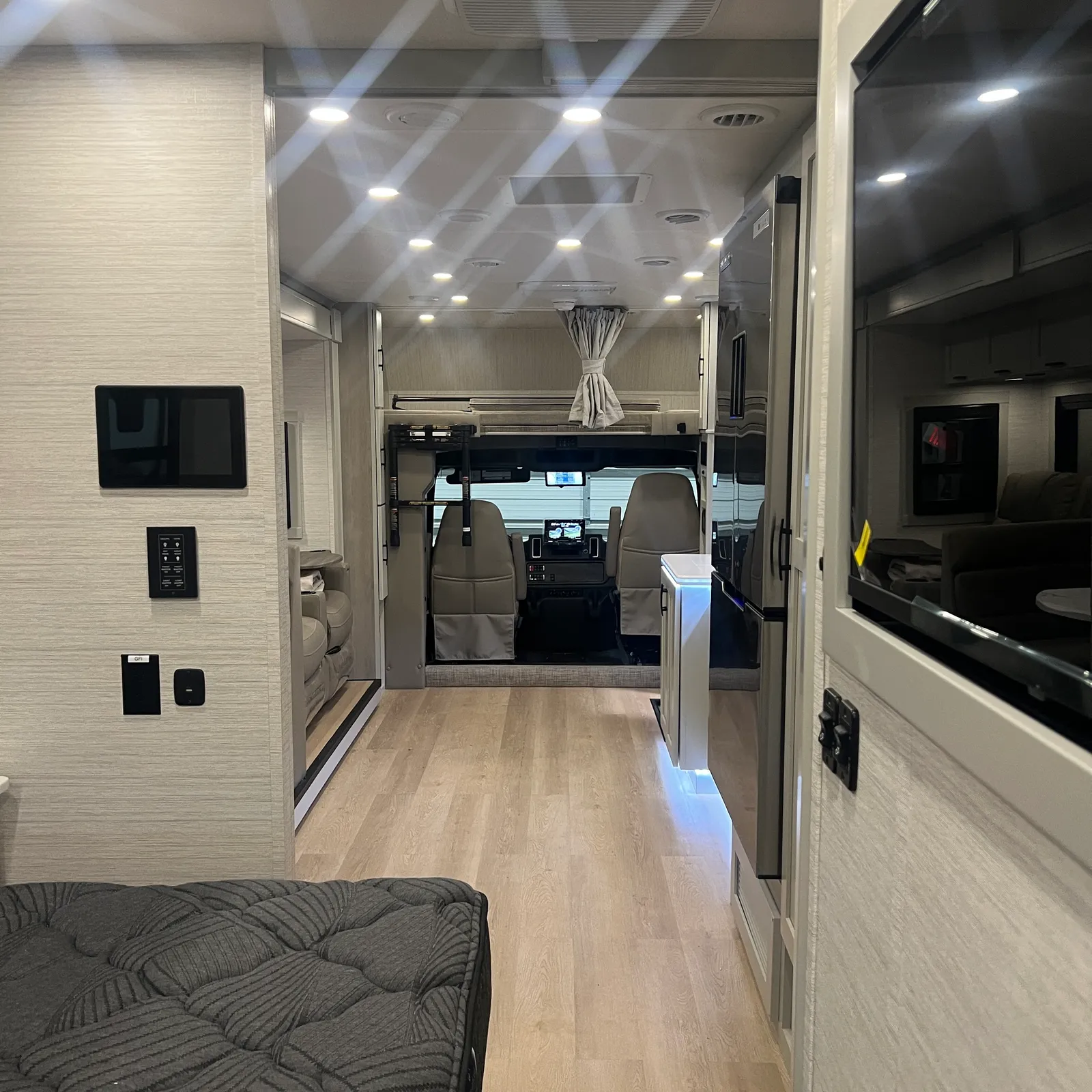 2027 Dynamax Corp Europa 31SS Super C motorhome, motorhome interior with living area, cockpit view, and overhead lighting